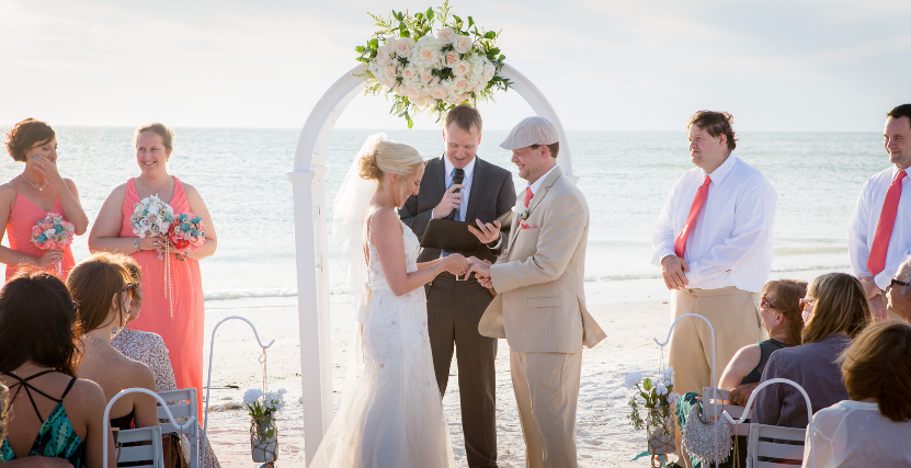White Wedding Arch with Couple Exchanging Vows on Honeymoon Island State Park Beach Wedding