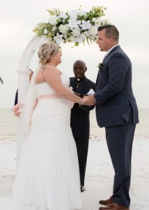 Formal attire on bride and groom at beach